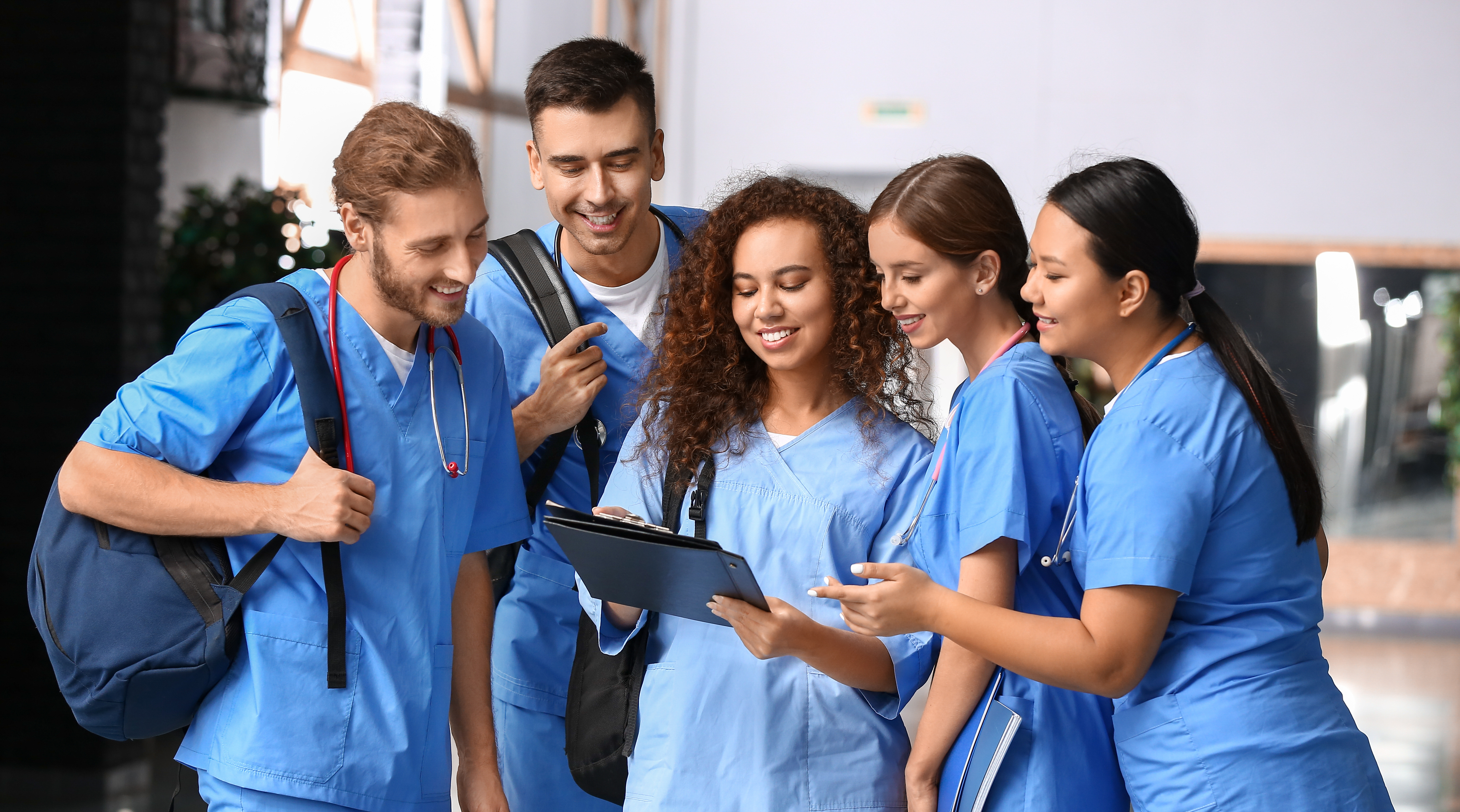 clinical personnel viewing a clipboard